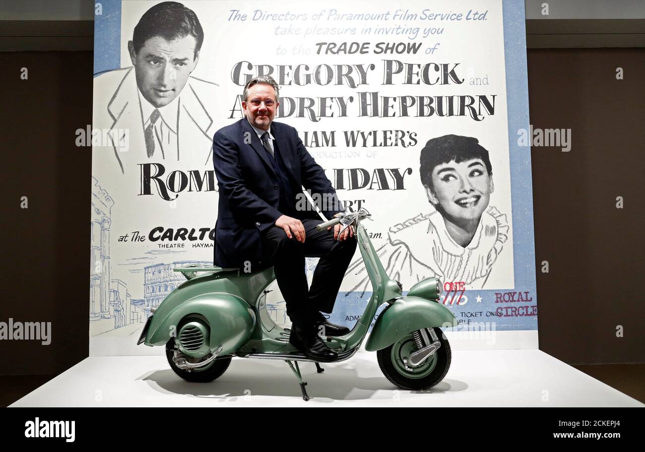Audrey Hepburn's son, Sean Hepburn Ferrer, poses on the Vespa scooter his  mother rode on in the 1953 movie "Roman Holiday" at the exhibition  "Intimate Audrey" in Brussels, Belgium, May 2, 2019.