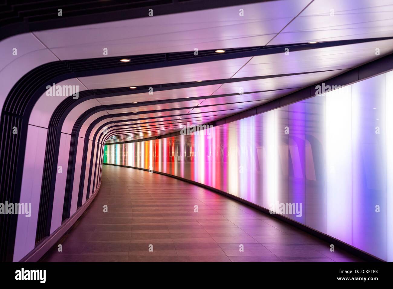 No people in empty One Pancras Square to King’s Cross St Pancras Underground Station illuminated colourful light tunnel in London United Kingdom Stock Photo
