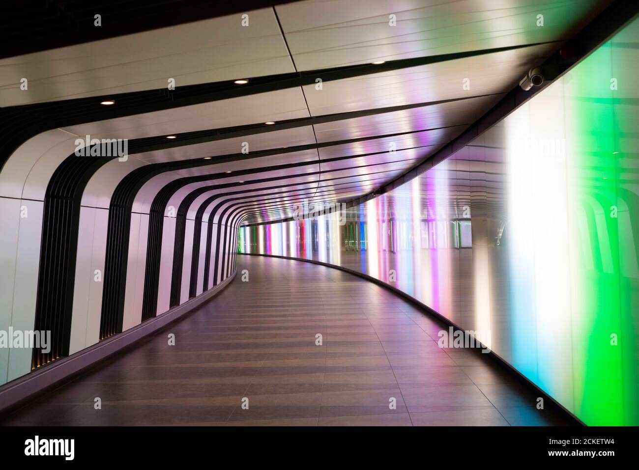 No people in the empty illuminated light tunnel and pedestrian subway at King's Cross St Pancras Underground Station in London UK Europe Stock Photo