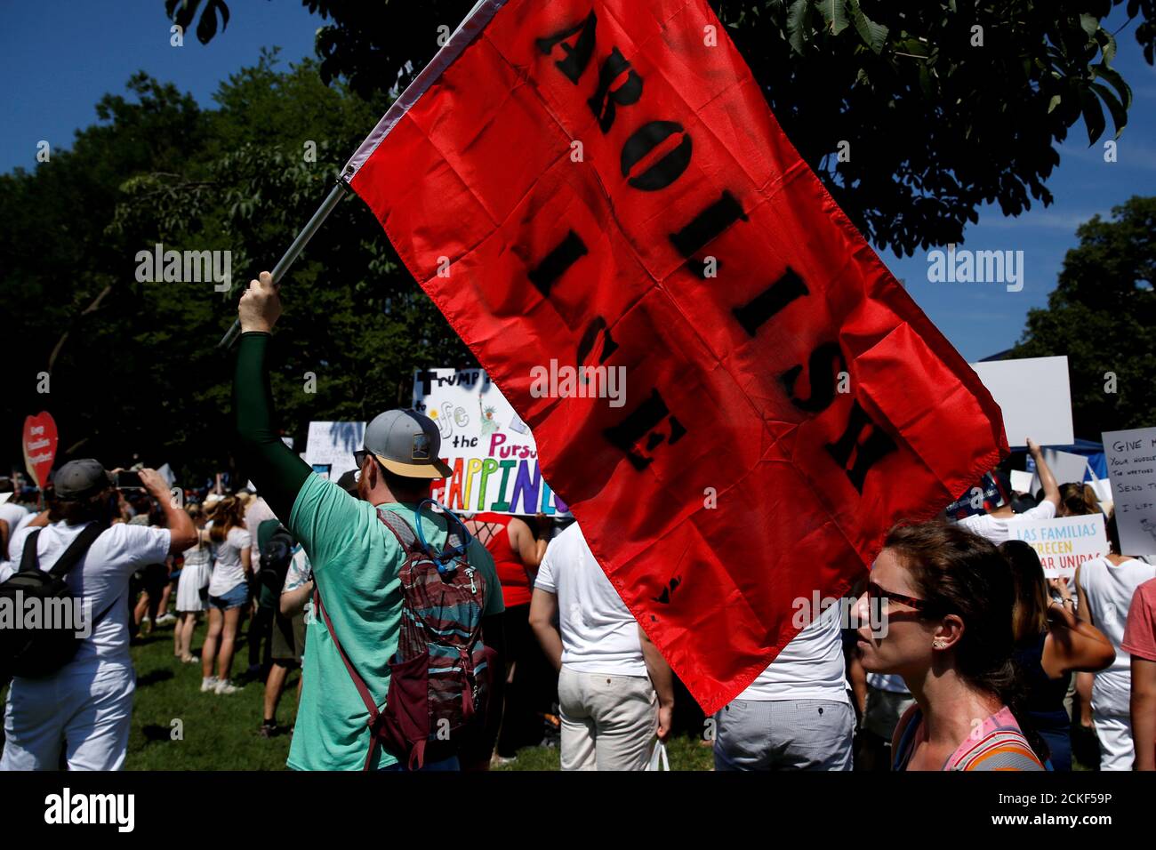 An immigration activists carries a flag calling for the abolishment of ICE, U.S. Immigration and Customs Enforcement, during rally to protest against the Trump Administration's immigration policy outside the White House  in Washington, U.S., June 30, 2018.      REUTERS/Joshua Roberts Stock Photo