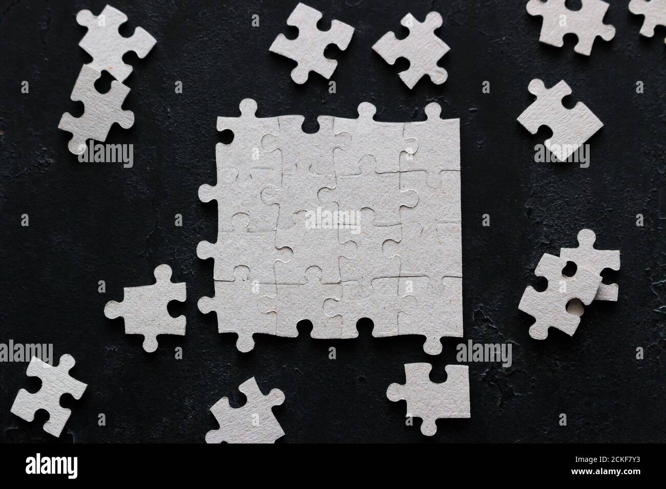 puzzle design and missing puzzle pieces on black background Stock Photo