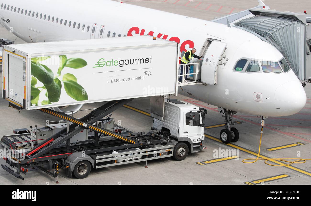 Gate Gourmet Staff Part Of Swiss Airline Catering Firm Gategroup Holdings Loads A Trolley Aboard An Airbus A3 214 Of Swiss Airlines At Zurich Airport Switzerland April 16 19 Picture Taken April 16