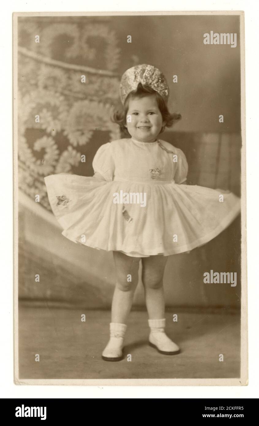 1950's studio portrait of chubby girl in her dancing dress, U.K Stock Photo