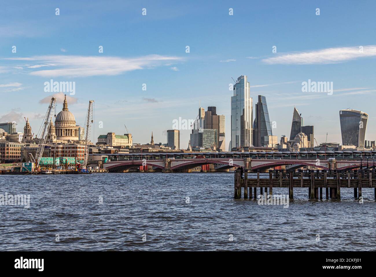 Looking towards Blackfriars Bridge across The River Thames towards the high rise buildings of The City Of London Stock Photo