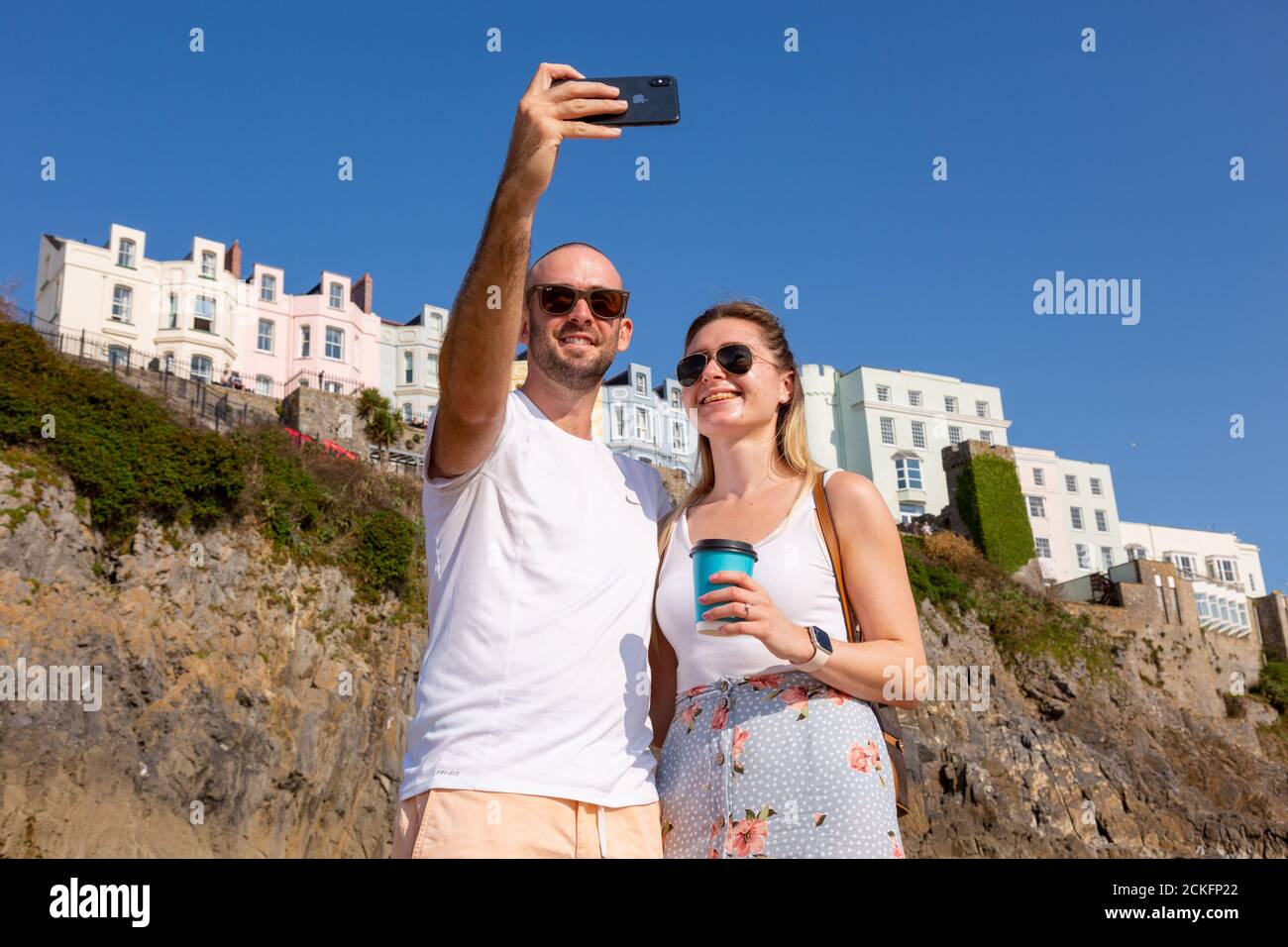 Tenby, Pembrokeshire, Wales, UK. 16th Sep, 2020. Kyle Davies with partner Elisha Kelly, from Pontyclun, have the south beach in Tenby, Pembrokeshire, almost to themselves, as another warm day is promised. Credit: Peter Lopeman/Alamy Live News Stock Photo