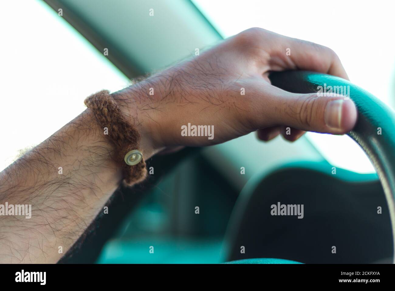 a hand on a steering wheel Stock Photo