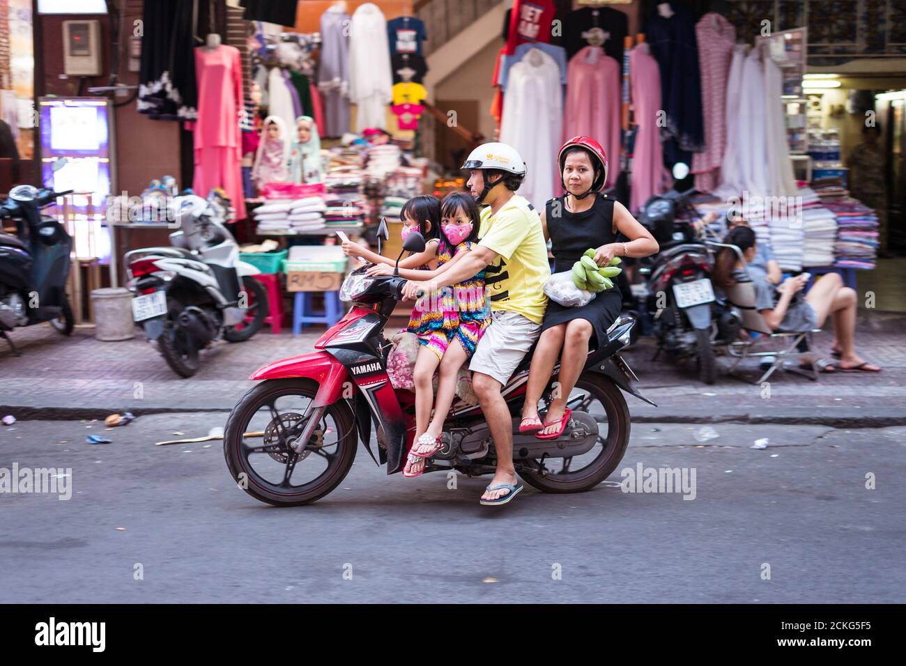 Ho Chi Minh / Vietnam - January 25, 2020: couple with two girls without helmets riding a motorcycle on the street in the capital Stock Photo