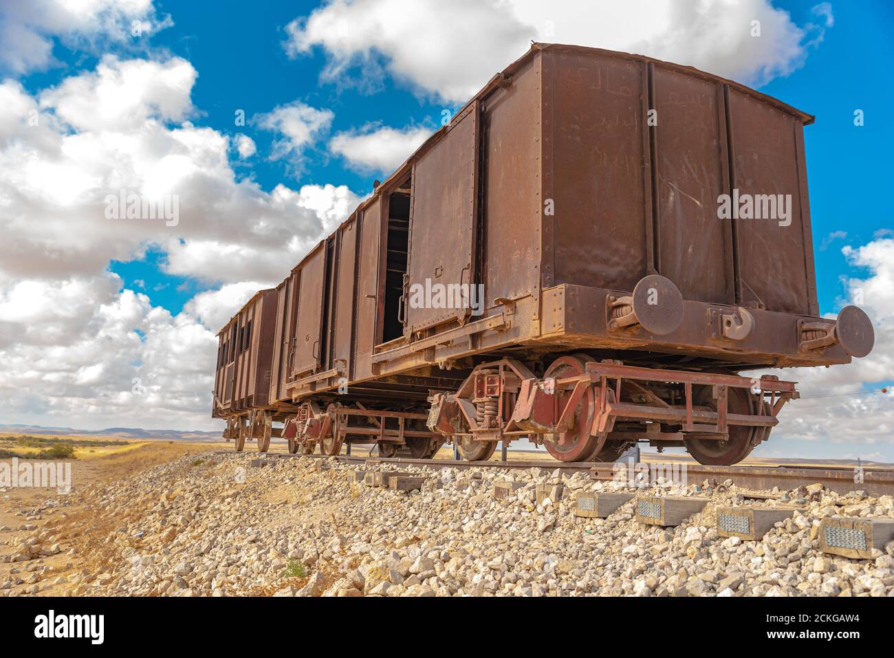 Rusty, deserted railcar on a disused sidetrack in the Negev desert, Israel Stock Photo