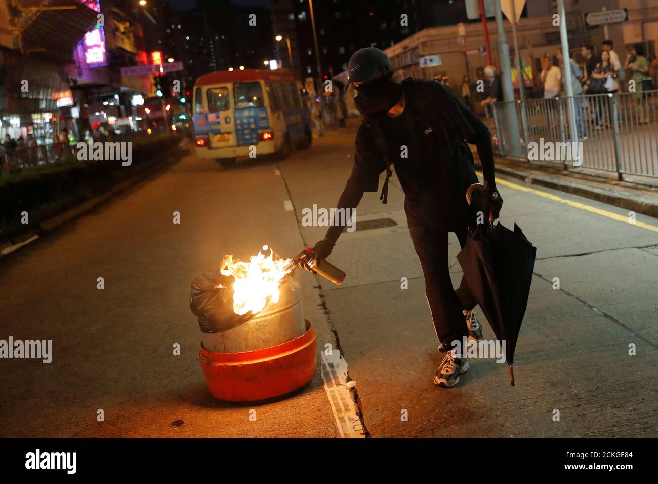 An anti-government protester set up a trash can on fire during a protest in Tsuen Wan, near the site where police shot a protester with live ammunition on China's National Day in Hong Kong, China October 13, 2019. REUTERS/Susana Vera Stock Photo