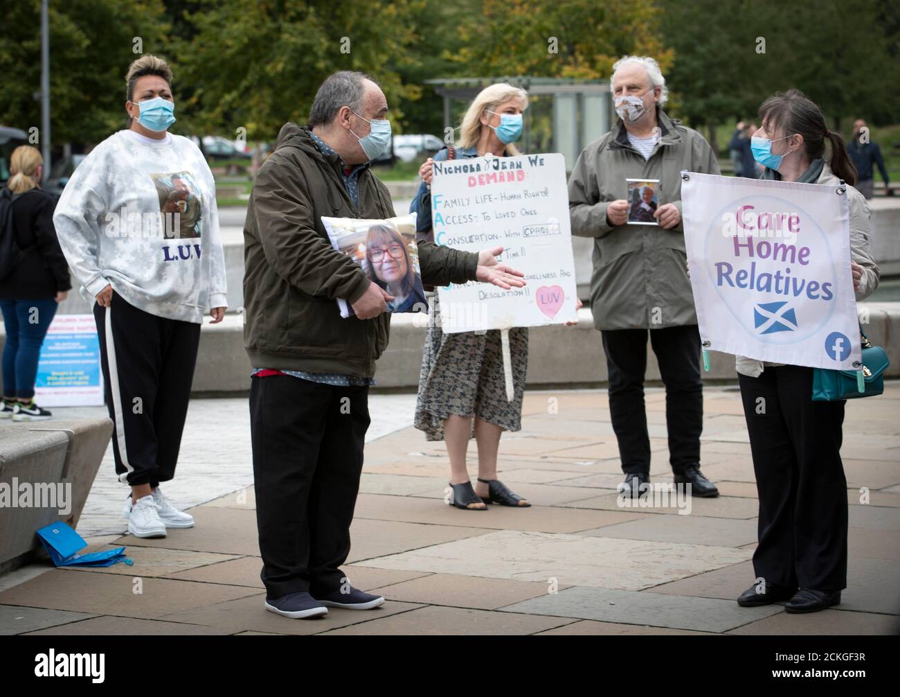 Members of the public take part in a demonstration outside the Scottish Parliament Building in Edinburgh, calling for MSPs to listen to their concerns surrounding care home visiting rules. Stock Photo