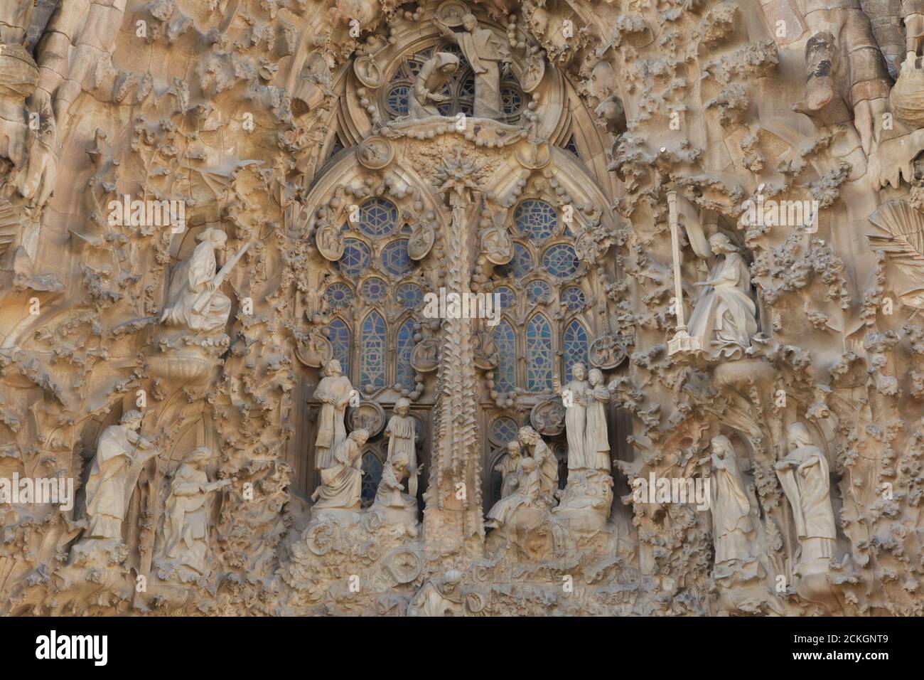 Angels and children playing and singing depicted in the Charity Hallway on the Nativity facade of the Sagrada Família (Basílica de la Sagrada Família) designed by Catalan modernist architect Antoni Gaudí in Barcelona, Catalonia, Spain. The Star of Bethlehem and the Annunciation to the Virgin Mary are depicted over the choir. The Nativity facade was designed by Antoni Gaudí himself and constructed between 1894 and 1930. The statues were carved by Catalan modernist sculptor Llorenç Matamala i Piñol. Stock Photo