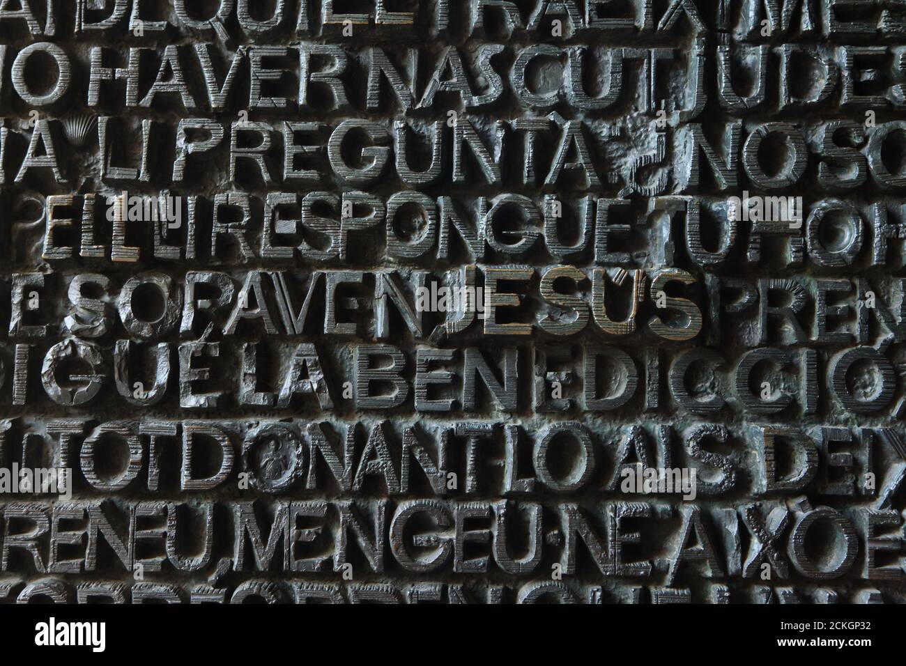 Name of Jesus depicted in the west bronze doors of the Sagrada Família (Basílica de la Sagrada Família) designed by Spanish modernist sculptor Josep Maria Subirachs in Barcelona, Catalonia, Spain. The bronze is the part of the Passion facade of the basilica completed in 1987. Stock Photo