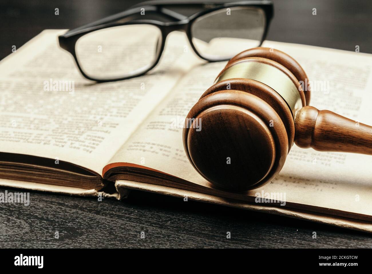 Brown wooden judge mallet on the background of open book Stock Photo