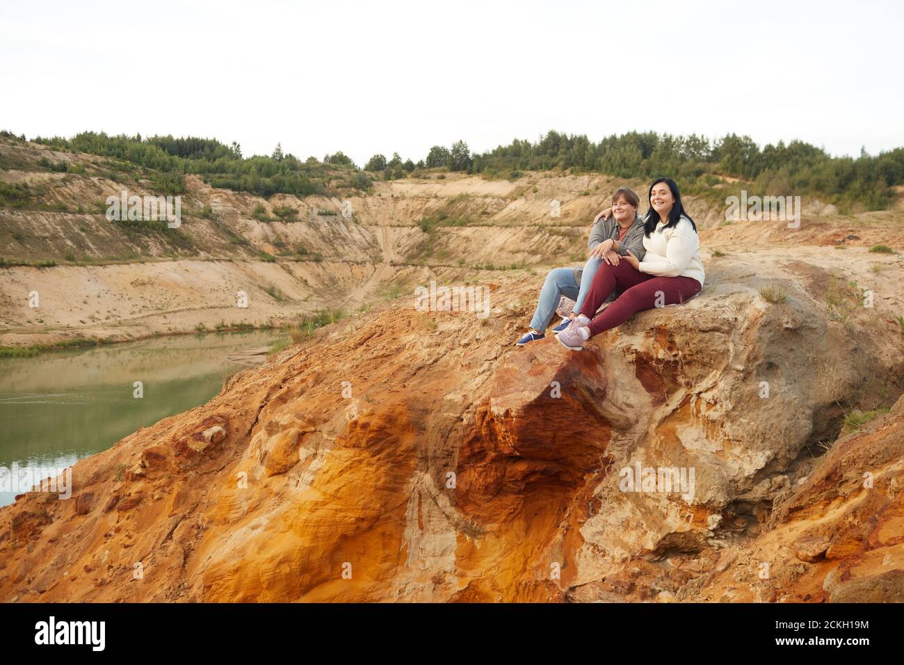 Two women sitting on hill hi-res stock photography and images - Alamy