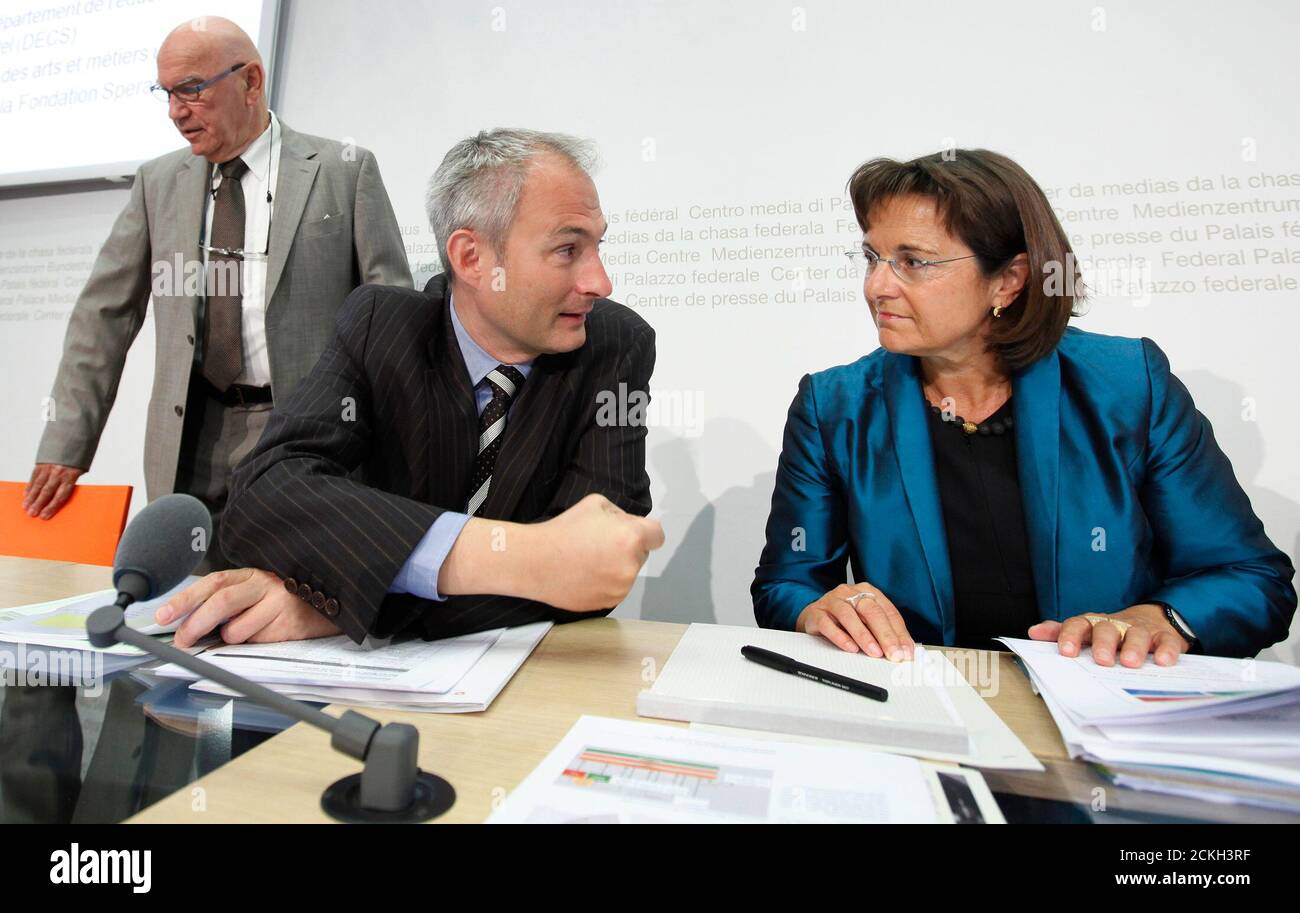 Ursula Renold (R), Director of the Federal bureau of vocational education and technology speaks to Bernhard Pulver (C), Cantonal Councillor of the canton Bern next to National Councillor Otto Ineichen before a news conference on school leaver without degree in Bern June 20, 2011. REUTERS/Pascal Lauener (SWITZERLAND - Tags: POLITICS) Stock Photo