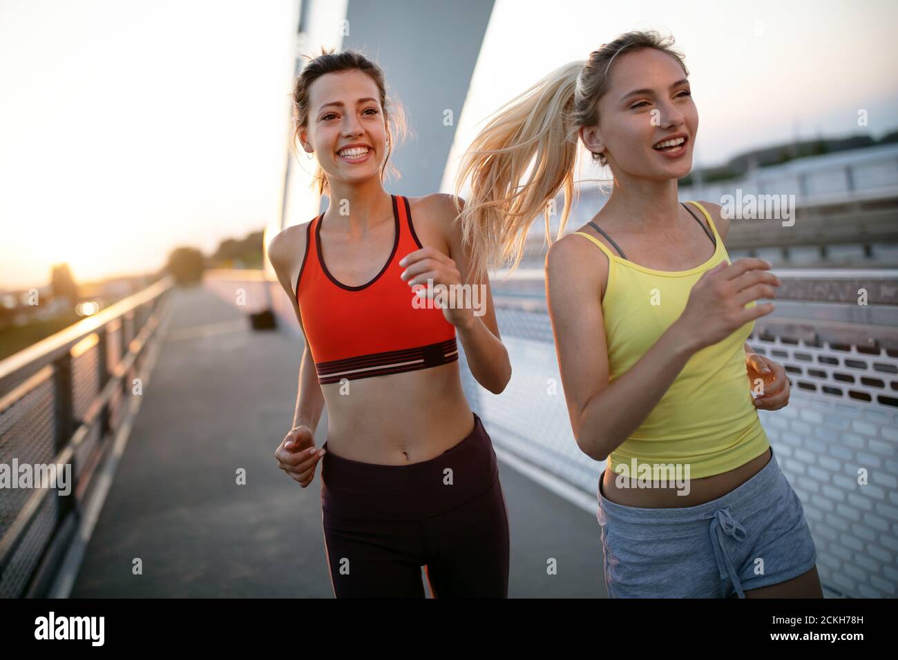 Fit happy friends jogging and running together outdoor in city Stock ...