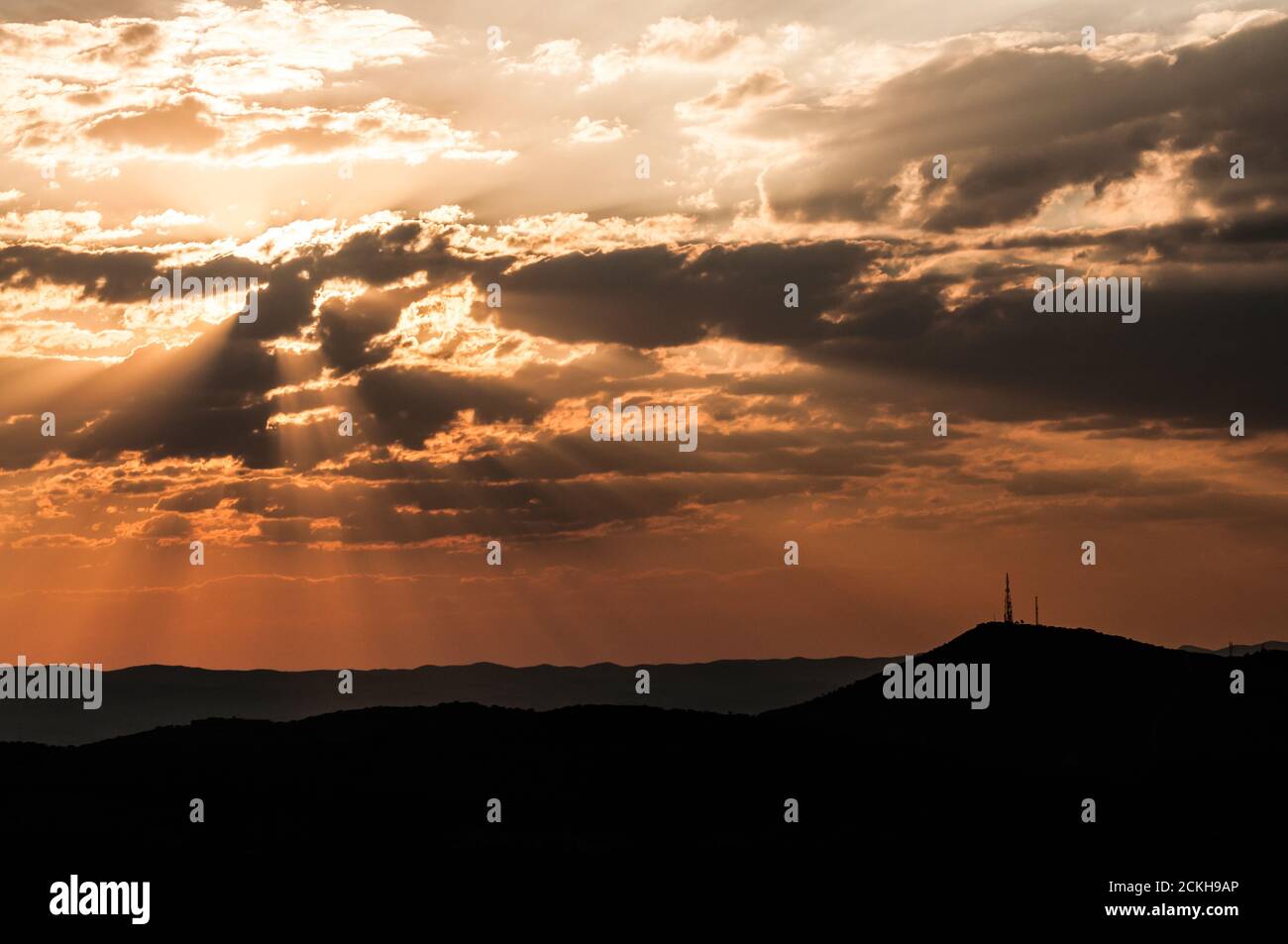 Sun among clouds during sunset above Windhoek in Namibia Stock Photo