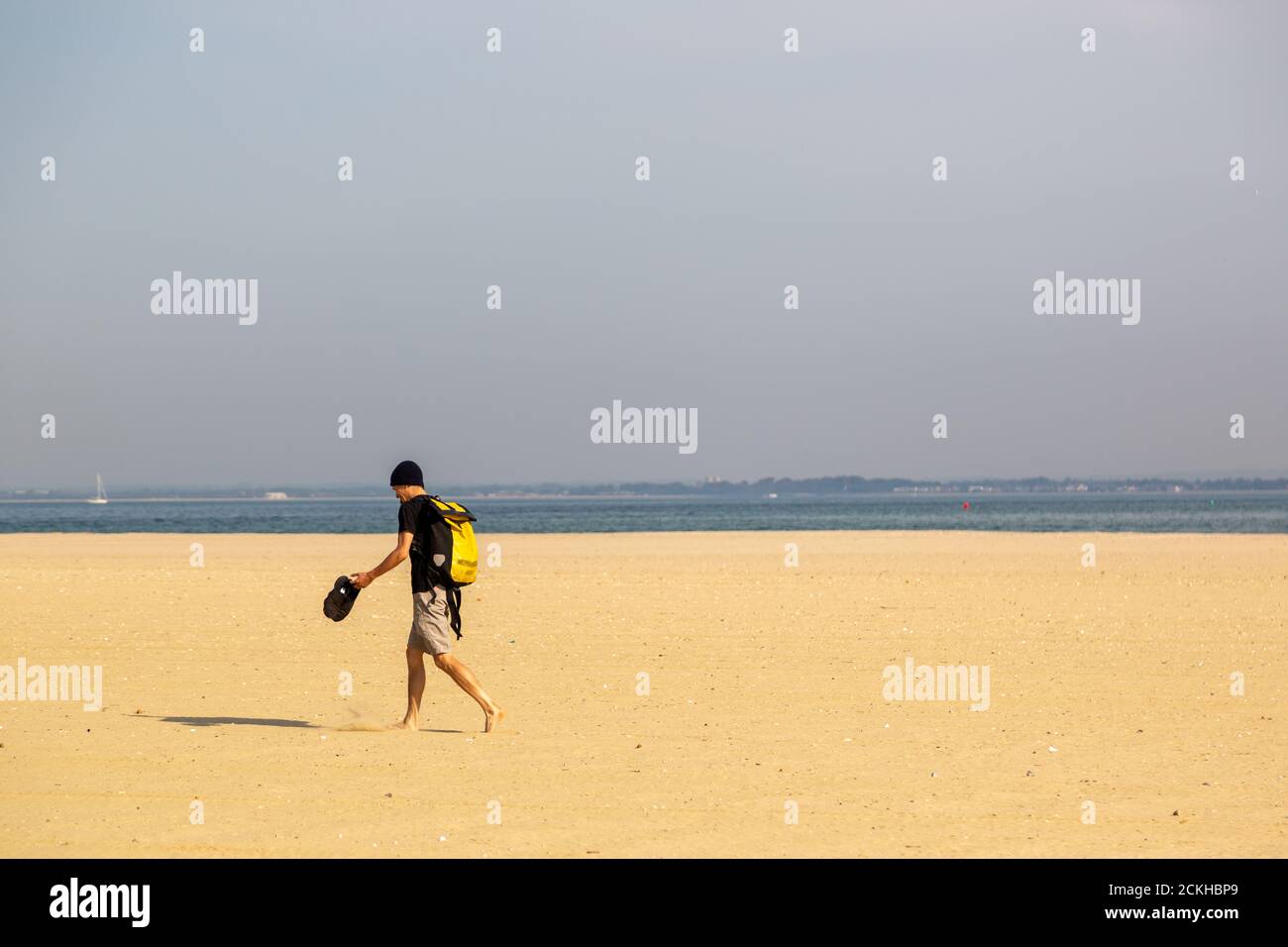 Man walking barefoot on beach hi-res stock photography and images - Alamy