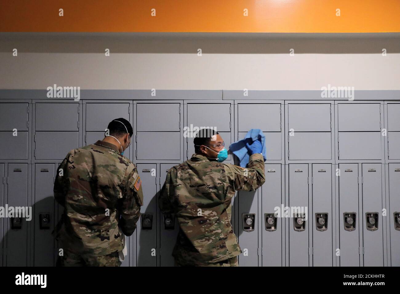 Members of Joint Task Force 2, composed of soldiers and airmen from the New York Army and Air National Guard, work to sanitize the New Rochelle High School during the coronavirus disease (COVID-19) outbreak in New Rochelle, New York, U.S., March 21, 2020. REUTERS/Andrew Kelly Stock Photo