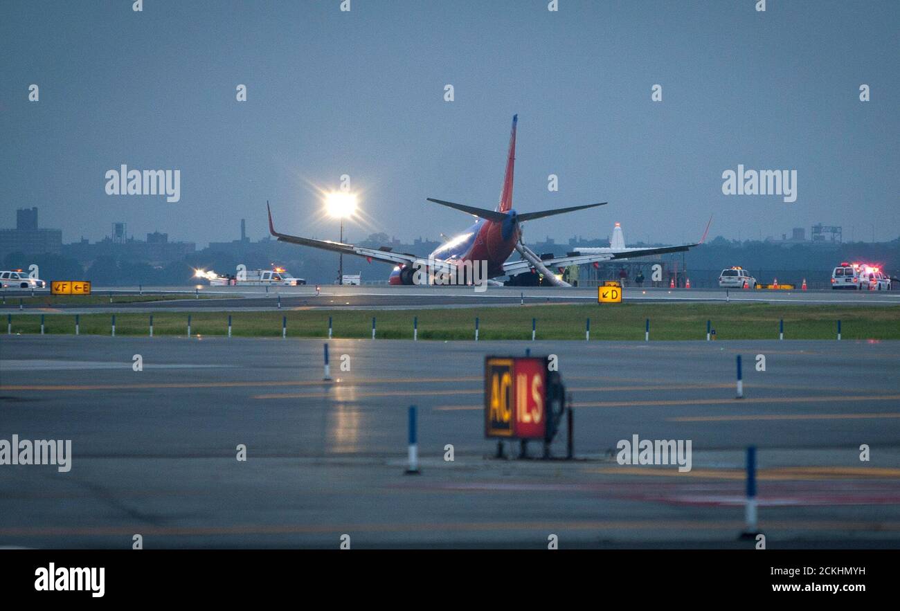 A Southwest Airlines Boeing 737 sits on the tarmac at LaGuardia airport after it made an emergency landing in New York July 22, 2013. Several people were injured when the Flight 345 with 150 people on board landed at New York City's LaGuardia Airport without its nose gear, officials said.   REUTERS/Carlo Allegri  (UNITED STATES - Tags: DISASTER TRANSPORT) Stock Photo