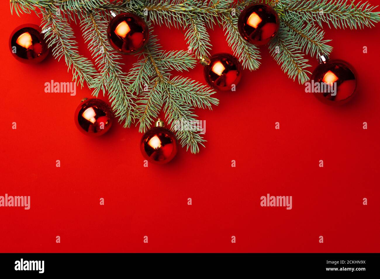 Christmas background with fir branches and balls on red Stock Photo - Alamy