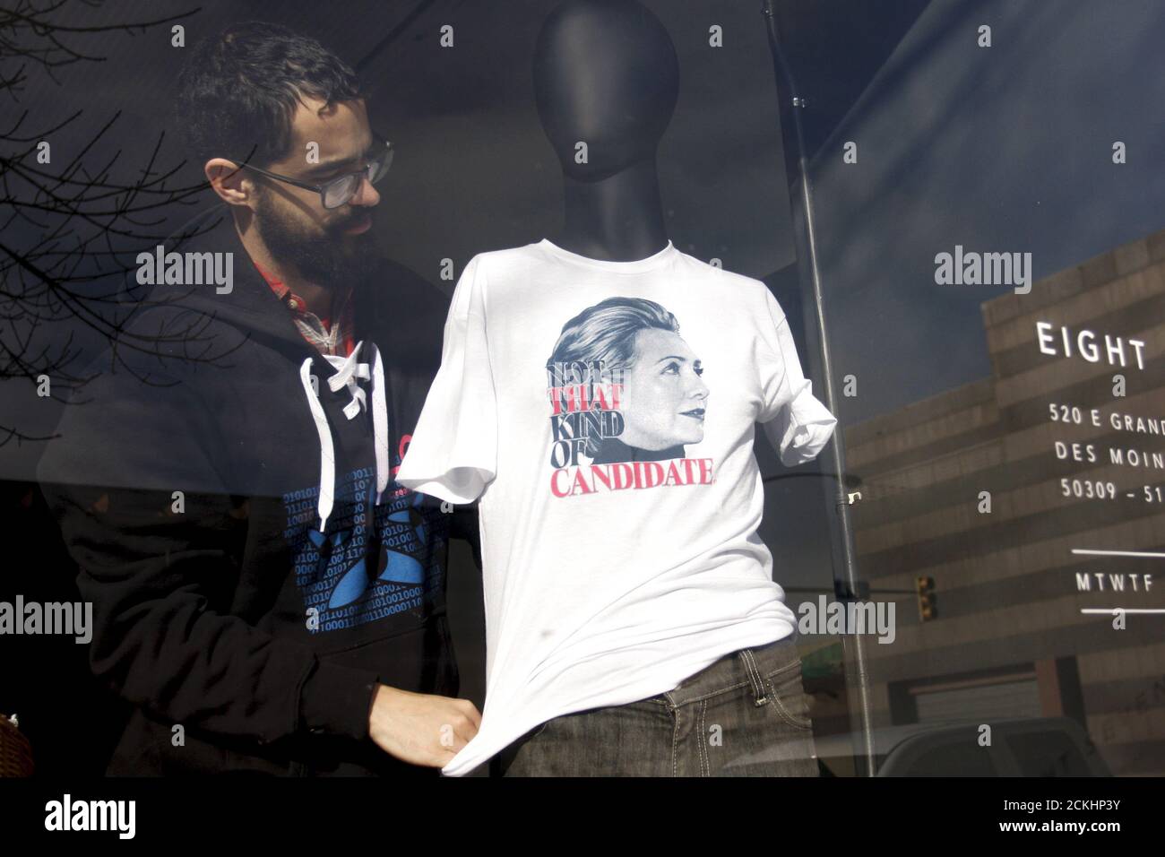 Levi Biel places a shirt of . Democratic presidential candidate Hillary  Clinton on a mannequin before actress and screenwriter Lena Dunham speaks  at Eight Seven Central screen printers in Des Moines, Iowa,