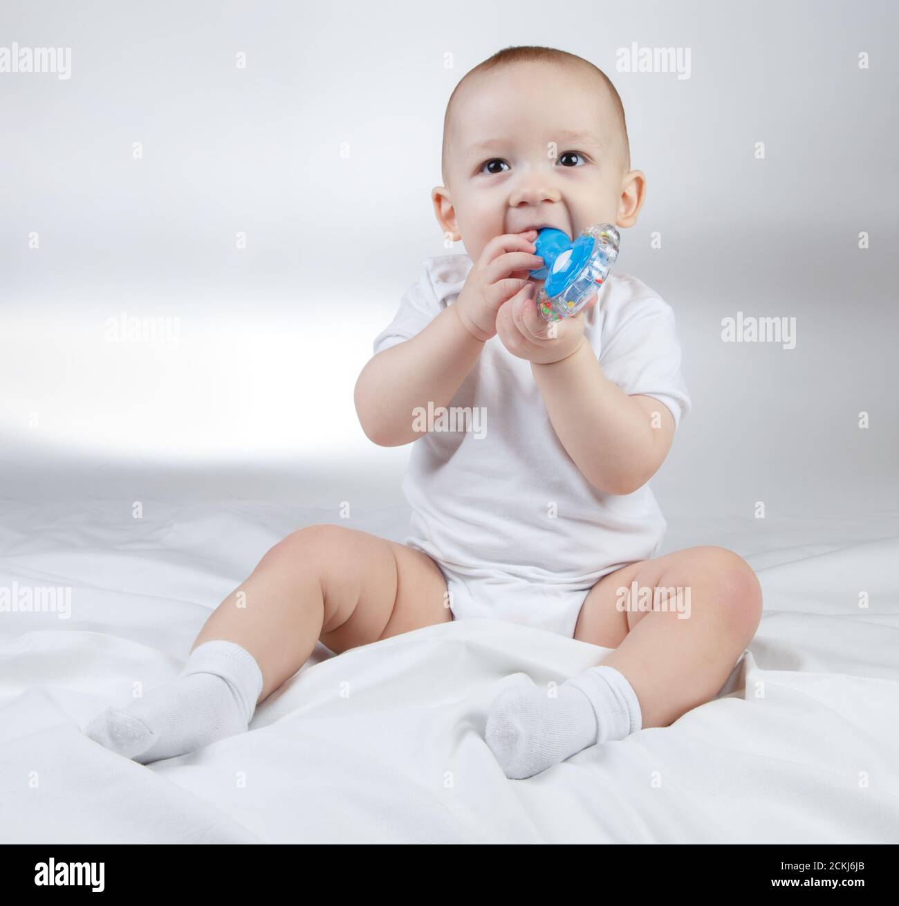 photo-of-a-ten-month-old-baby-with-blue-rattle-stock-photo-alamy