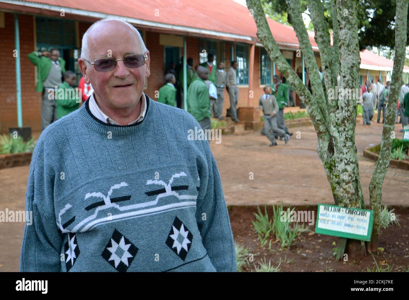 Brother Colm O'Connell poses for a photo at St Patrick's High School, where trees have been planted to honour former pupils who have gone on to become world champions, in Kenya's Iten village June 28, 2012. O'Connell, an Irish missionary who started the first athletics training camp in the Kenyan highlands, never imagined a small village in the Great Rift Valley would become a production line of running talent. Picture taken June 28, 2012. REUTERS/Drazen Jorgic (KENYA - Tags: SPORT ATHLETICS OLYMPICS) Stock Photo