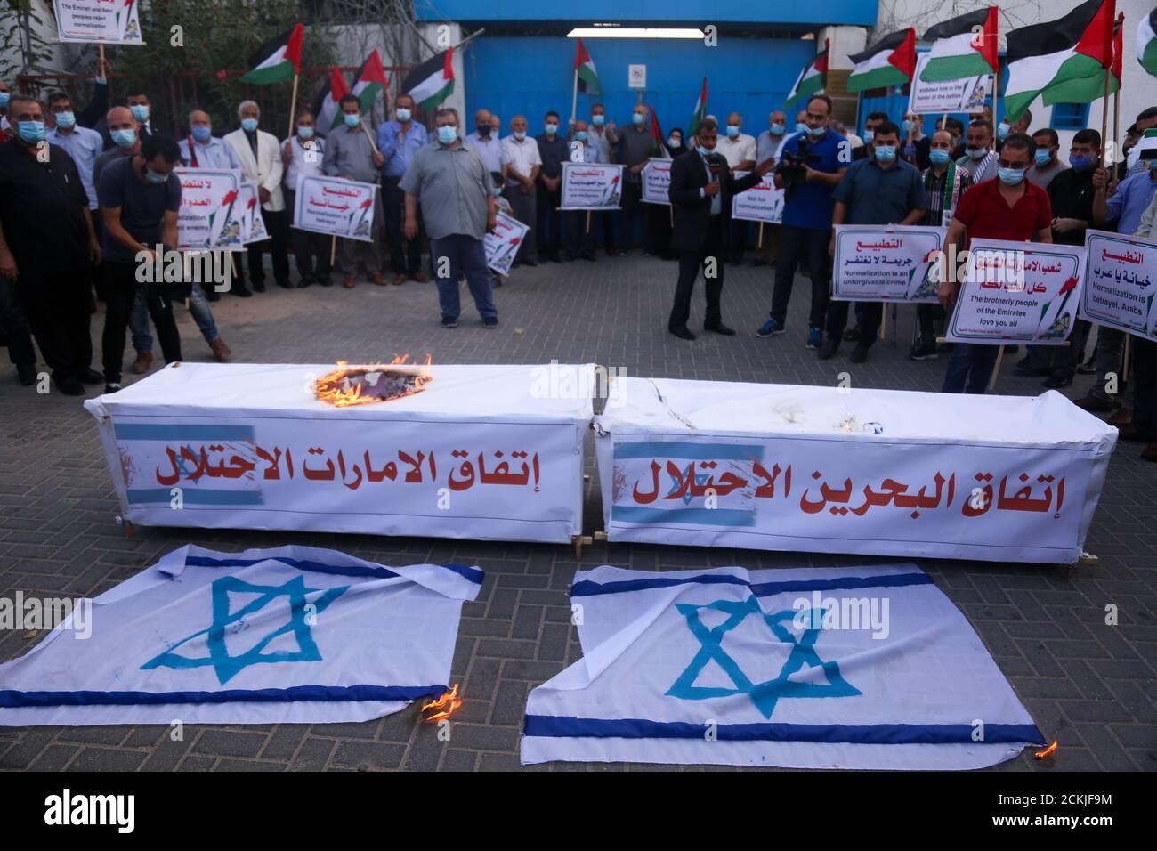 September 15, 2020: Gaza, Palestine.15 September 2020. Palestinians hold a protest outside the UN headquarters in Gaza City as the UAE and Bahrain sign their normalisation agreements with Israel in Washington. Protesters burnt the Israeli flag and carried banners denouncing the deal as ''the deal of shame'', and the normalisation of ties as a betrayal by the Arab states. While the White House has described the accords as a ''declaration of peace'', Palestinians have fully rejected them as they feel even more isolated in resisting the Israeli occupation, while their leaders have called for a l Stock Photo