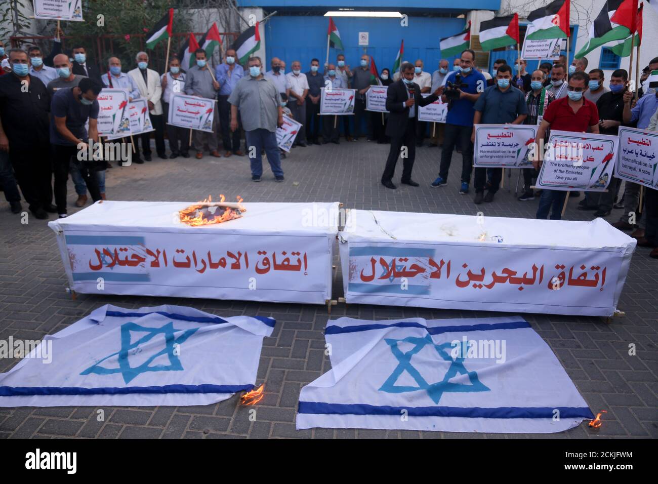 September 15, 2020: Gaza, Palestine.15 September 2020. Palestinians hold a protest outside the UN headquarters in Gaza City as the UAE and Bahrain sign their normalisation agreements with Israel in Washington. Protesters burnt the Israeli flag and  carried banners denouncing the deal as ''the deal of shame'', and the normalisation of ties as a betrayal by the Arab states. While the White House has described the accords as a ''declaration of peace'', Palestinians have fully rejected them as they feel even more isolated in resisting the Israeli occupation, while their leaders have called for a l Stock Photo