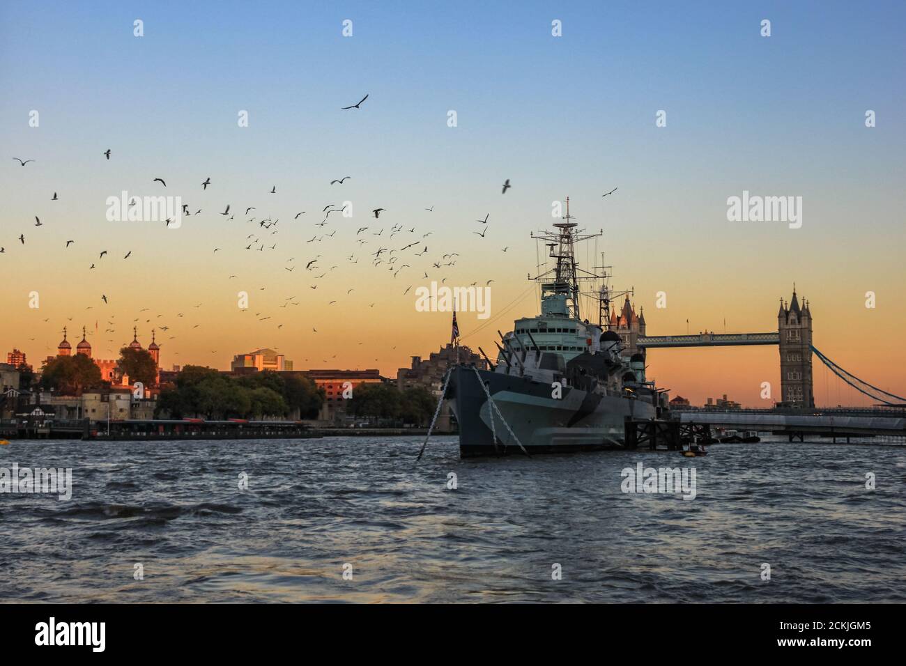 Sunset over London - Beautiful view of the HMS Belfast at sunset, in front of Tower Bridge and the Tower of London Stock Photo