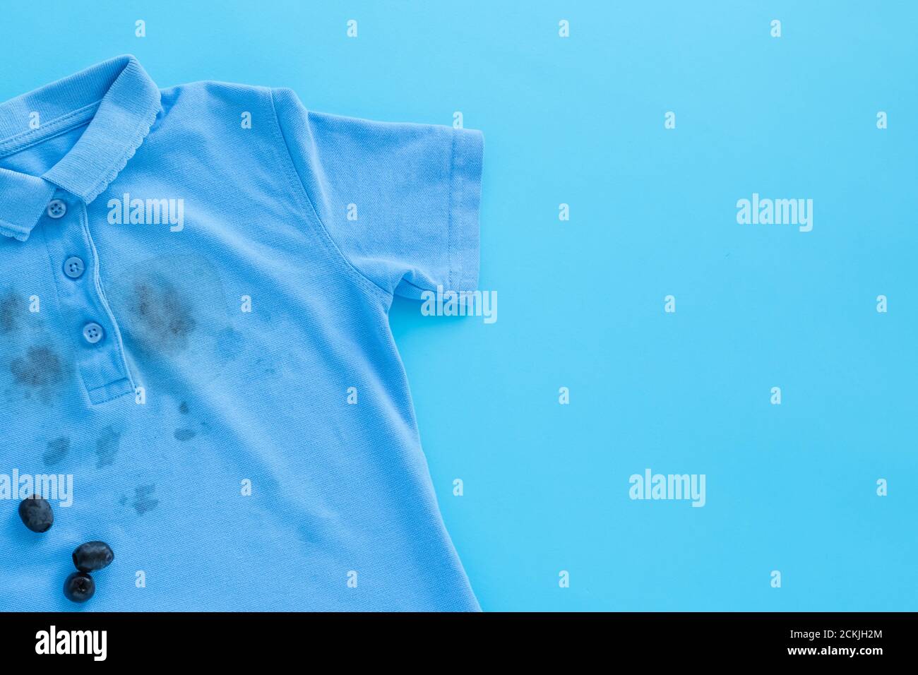 close up dirty stain of black olives on clothes Stock Photo