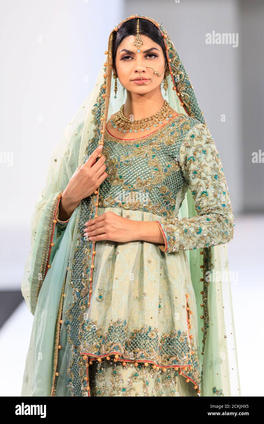 Model wearing Asian wedding dress bridal wear, gown by Sache by Asif, jade  green, National Asian Wedding Show fashion runway, London Stock Photo -  Alamy