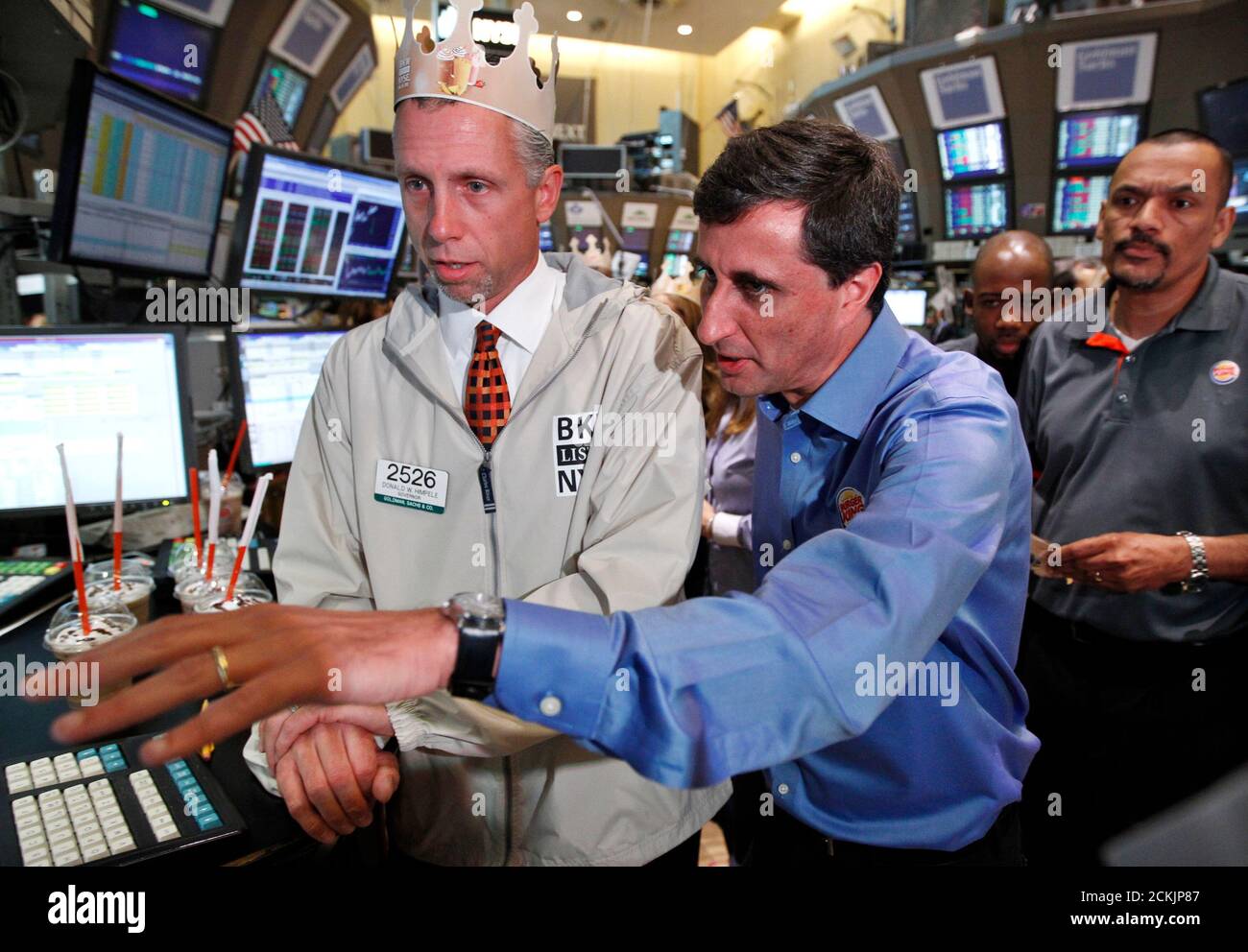 Burger King Corp. CEO Bernardo Hees (C) talks with specialist Donald Himpele (L) after his company's stock began trading at the New York Stock Exchange June 20, 2012. Shares of Burger King Worldwide Holdings Inc opened at $14.50 on Wednesday, as it started its first round of trading, less than two years of going private in a $3.26 billion sale to Brazilian investment fund 3G Capital Management LLC. REUTERS/Brendan McDermid (UNITED STATESBUSINESS - Tags: FOOD BUSINESS) Stock Photo