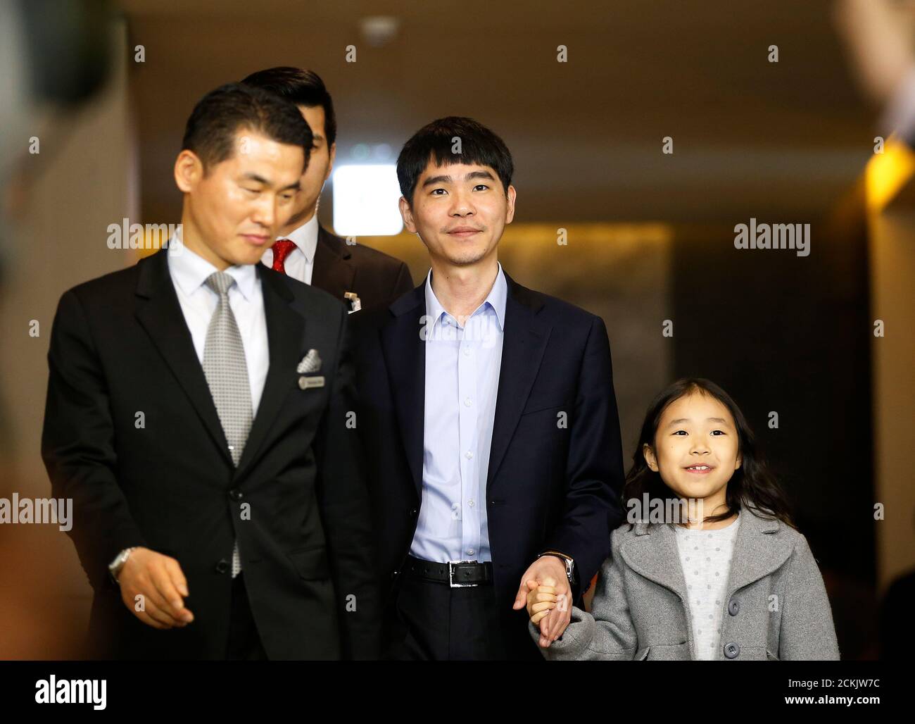 The world's top Go player Lee Sedol walks with his daughter Lee Hye-lim as  he heads for the venue of the last match of the Google DeepMind Challenge  Match against Google's artificial