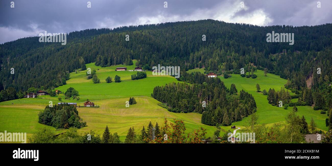 Panorama of a farm landscape with mountain farmsteads  on a hill slope in the Pustervalley of South Tirol (Alto Aldige) near Innichen (San Candido), Stock Photo