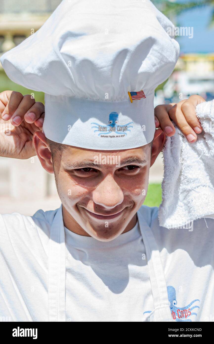 Miami Beach Florida,Hispanic Latin Latino,male teen teenage teenager youth boy,student wearing putting on chef's hat Stock Photo