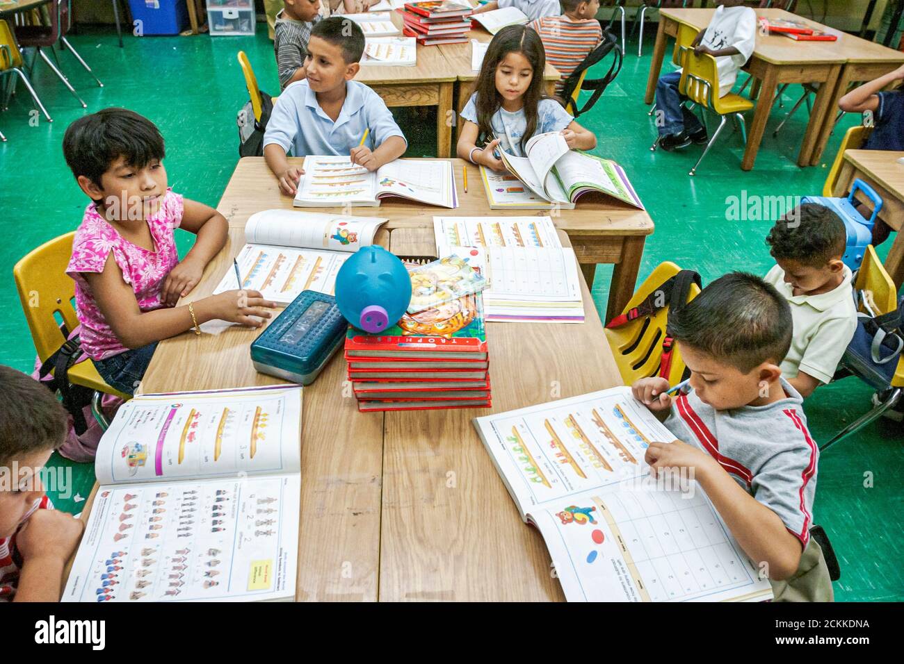 Miami Florida,Frederick Douglass Elementary School,low income community,Hispanic students girls boys classroom desks reading working workbook book Stock Photo