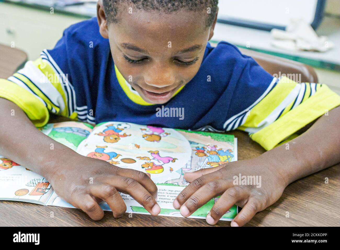 Miami Florida,Frederick Douglass Elementary School,inside primary,low income community,Black student students people boy classroom desks reading book Stock Photo