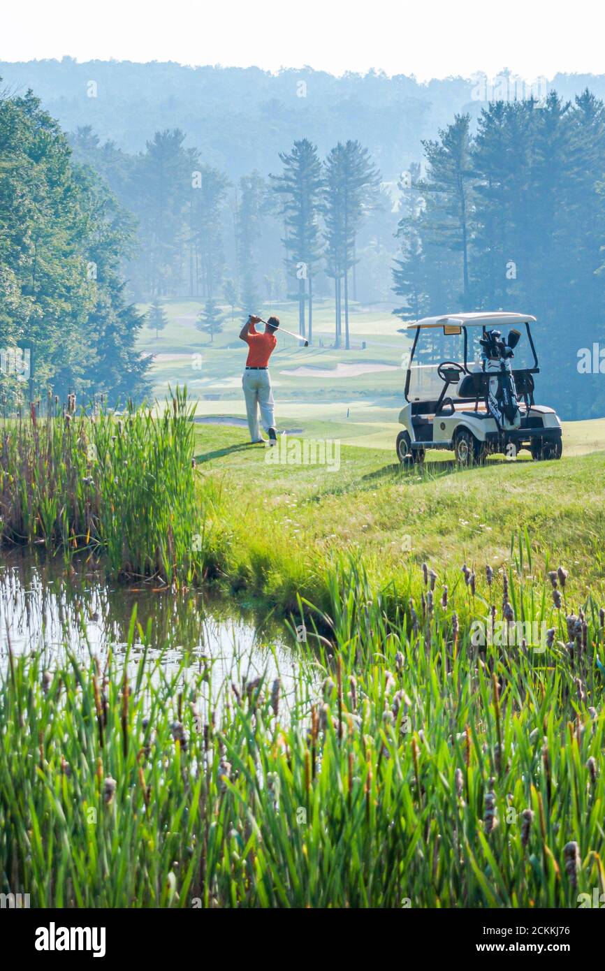 Pennsylvania Pocono Mountains Woodloch Springs Golf Course,golfing golfer cart swings swinging, Stock Photo