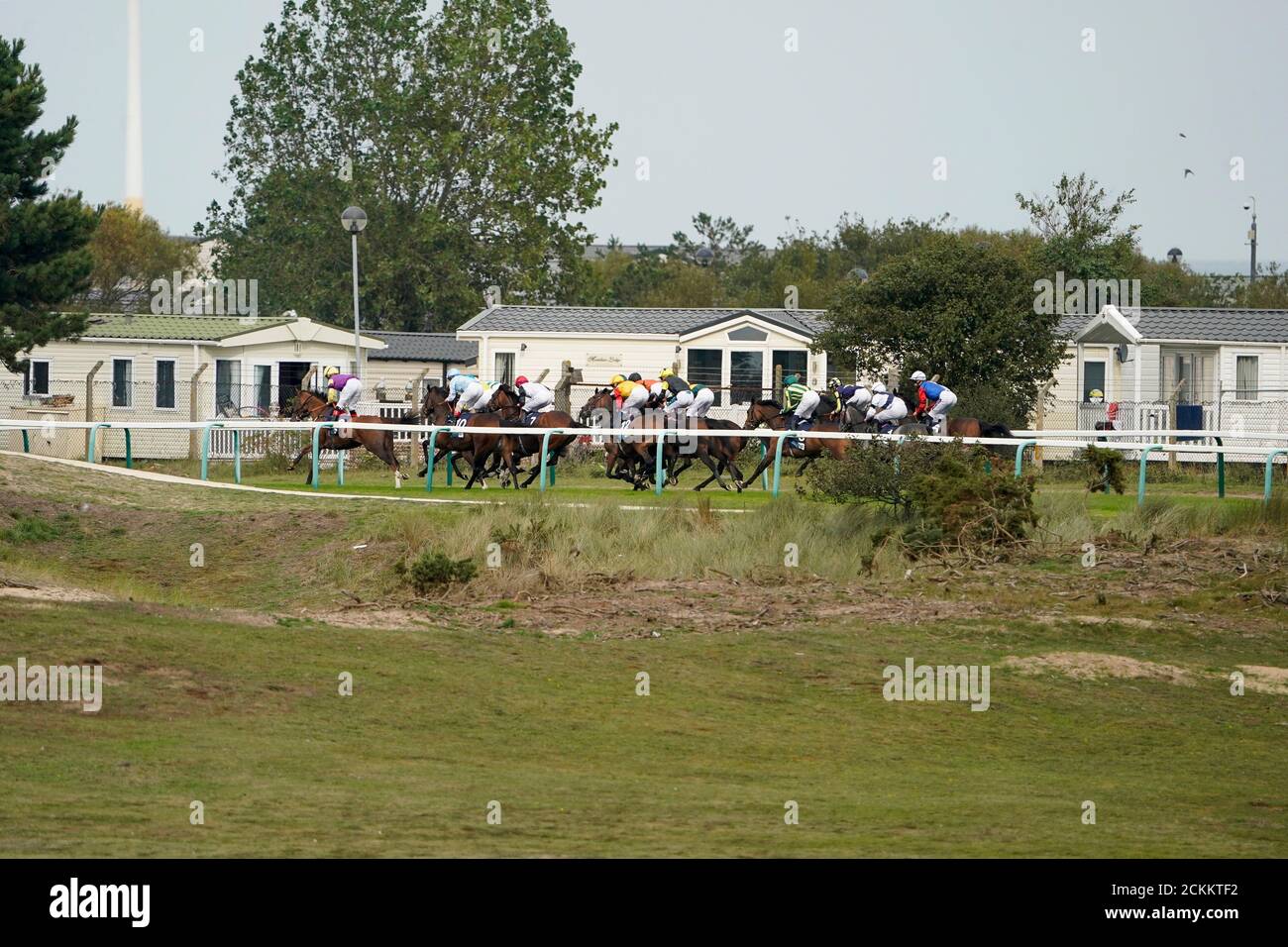 A general view as runners race down the back straight in The EBF Stallions John Musker Fillies' Stakes at Great Yarmouth Racecourse. Stock Photo