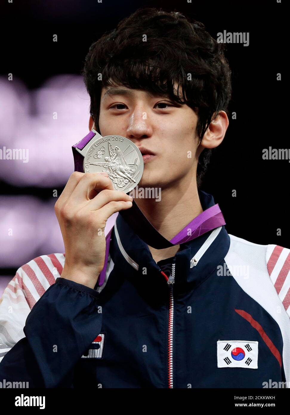 Silver medallist South Korea's Lee Dae-hoon kisses his medal at the men's  -58kg taekwondo victory ceremony during the London 2012 Olympic Games at  the ExCeL arena August 8, 2012. REUTERS/Stefano Rellandini (BRITAIN -