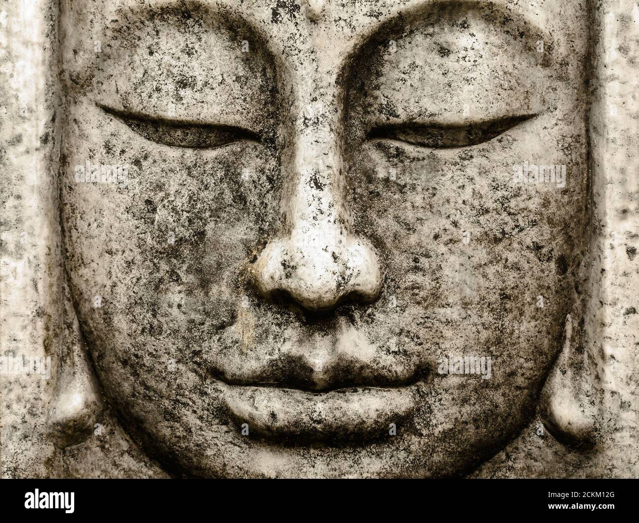 Head of a grey weathered old buddha statue Stock Photo
