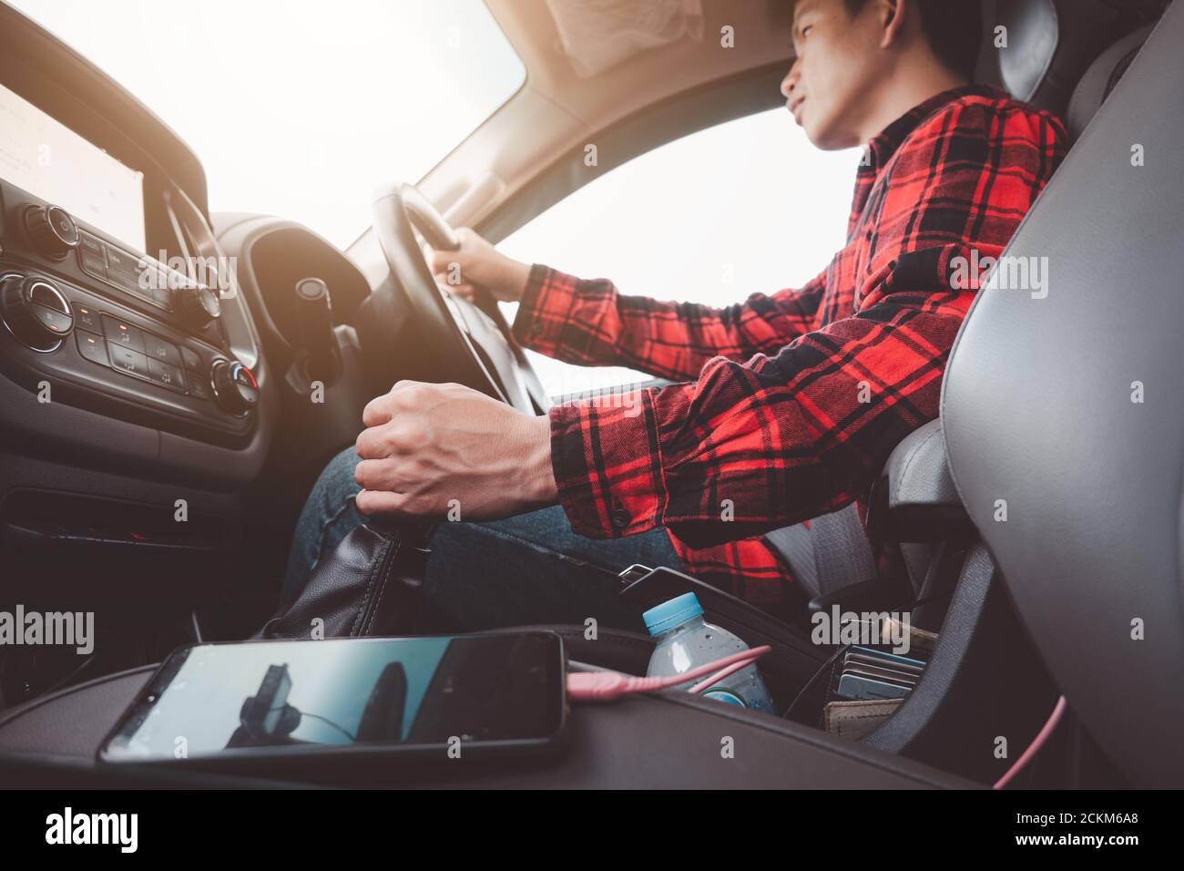 Car Driving Concept.Man driver shifting to drive mode or change gear .Close Up hand on transmission stick Stock Photo