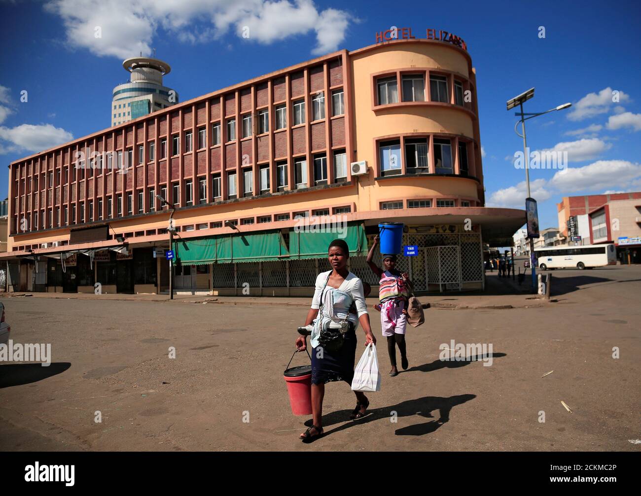 Women cross a deserted street during a 21-day nationwide lockdown called to help curb the spread of coronavirus disease (COVID-19), in Harare, Zimbabwe, April 3, 2020. REUTERS/Philimon Bulawayo Stock Photo