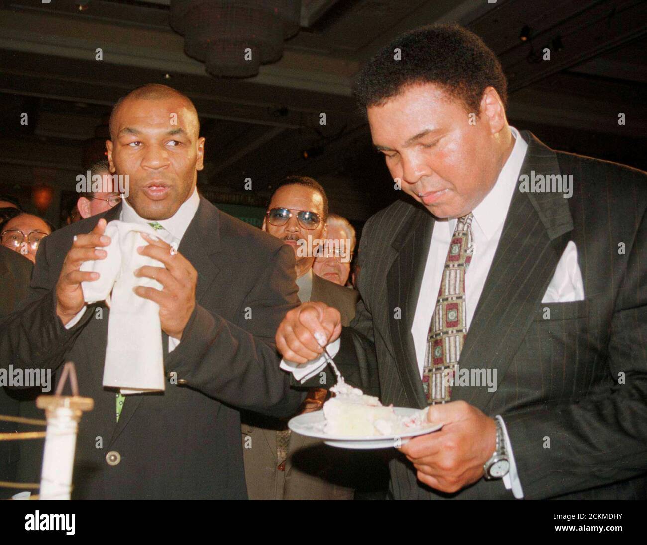 Boxing Great Muhammad Ali R Eats A Piece Of His Birthday Cake As Boxer Mike Tyson Looks On At The Mgm Grand Hotel In Las Vegas Nevada In This January 17 1999