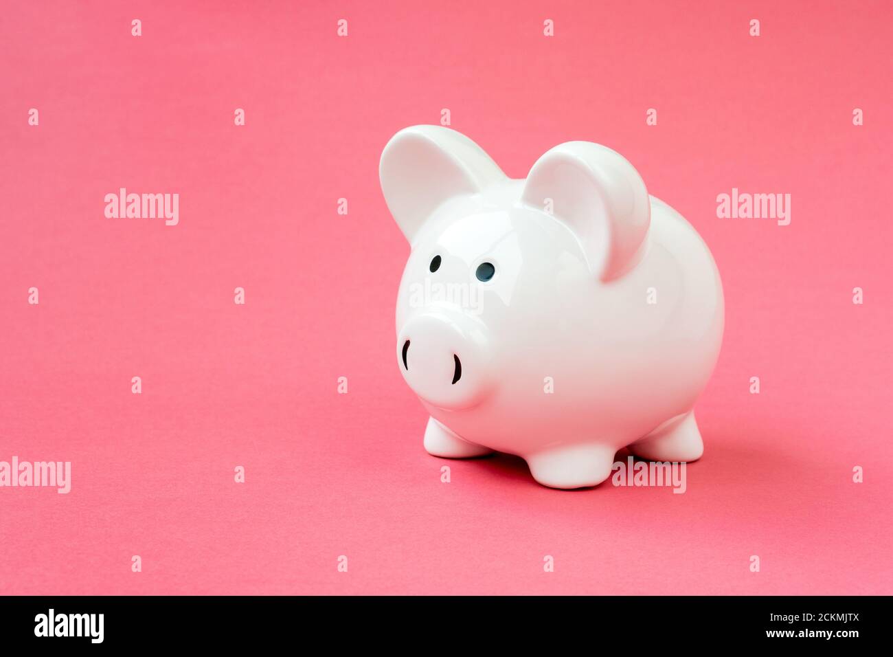 White ceramic piggy bank on the pink background. Copy space Stock Photo ...