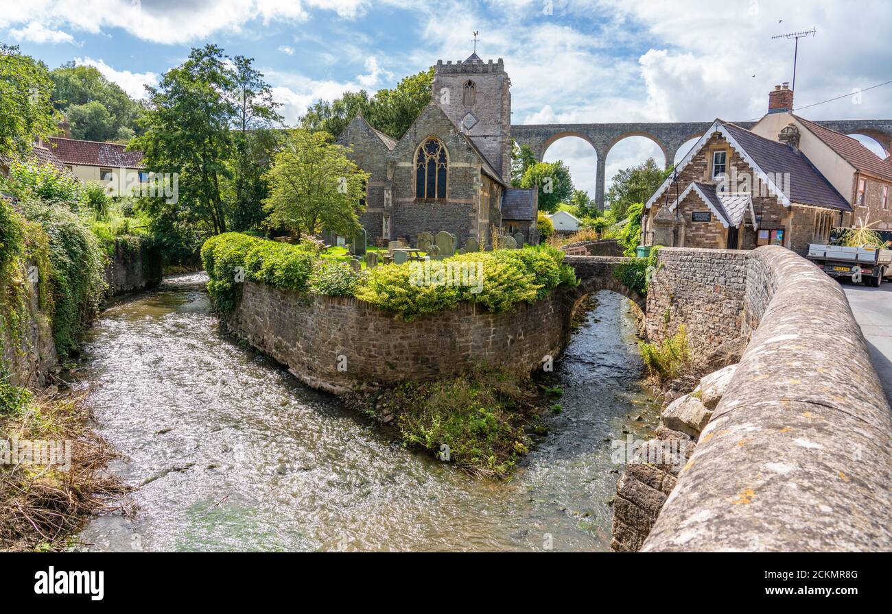 The River Chew with St Thomas a Becket church and the Pensford Viaduct in the village of Pensford near Bath in Somerset UK Stock Photo