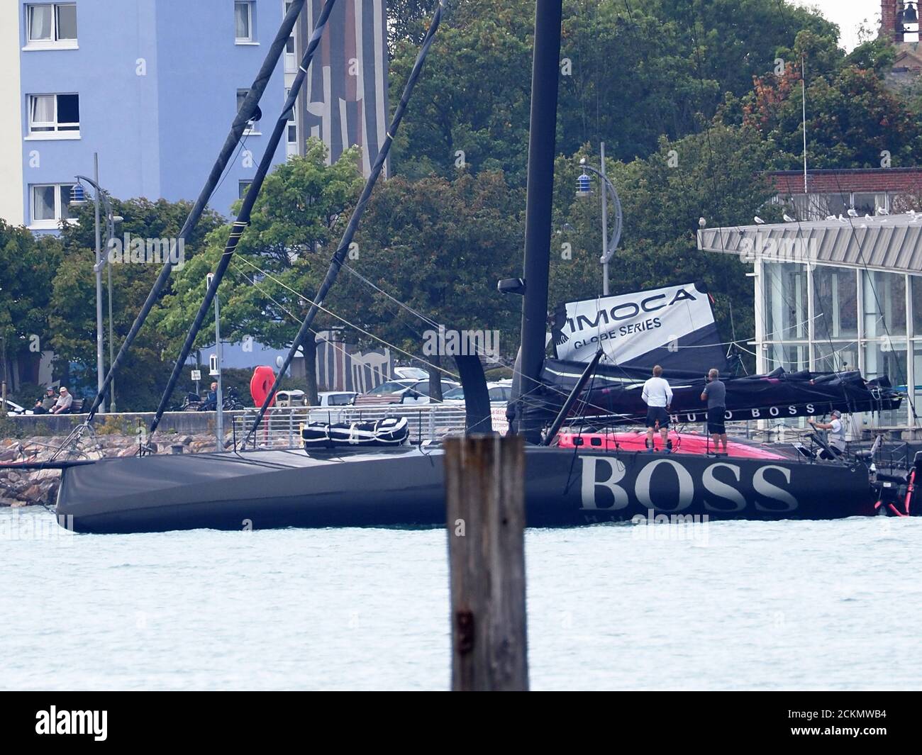 Portsmouth, Hampshire, UK. 16th September, 2020. Well known British yachtsman Alex Thomson was spotted preparing his distinctive black new Hugo Boss yacht for a training session this afternoon, with the help of his team near Portsmouth, in preparation for the Vendée Globe solo non stop around the world race which starts on 8 November.  Credit: James Bell/Alamy Live News Stock Photo