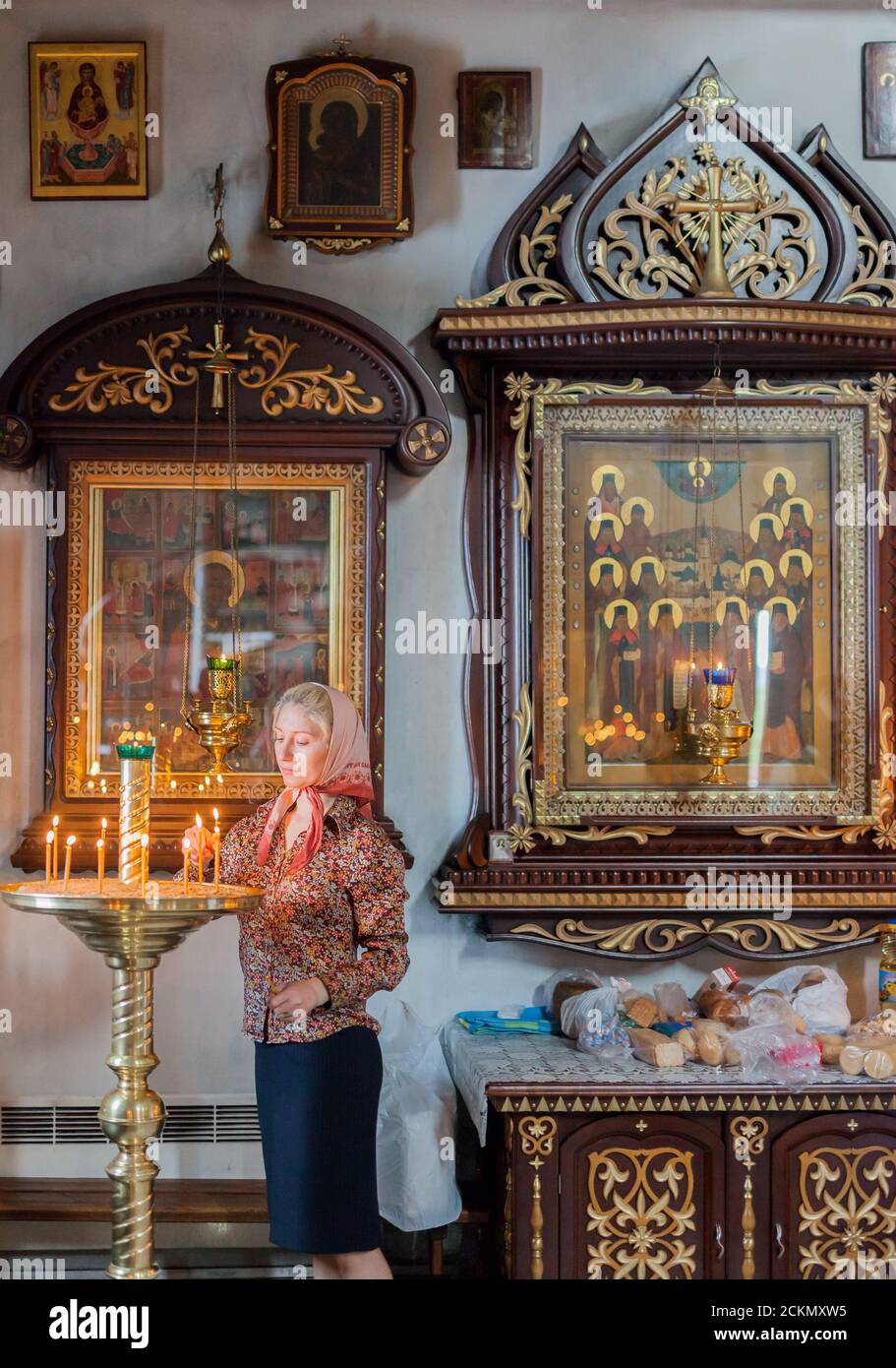 MURMANSK RUSSIA - 2014 SEPTEMBER 14. Russian woman with the candles in the Church of the Savior on the Waters. Stock Photo
